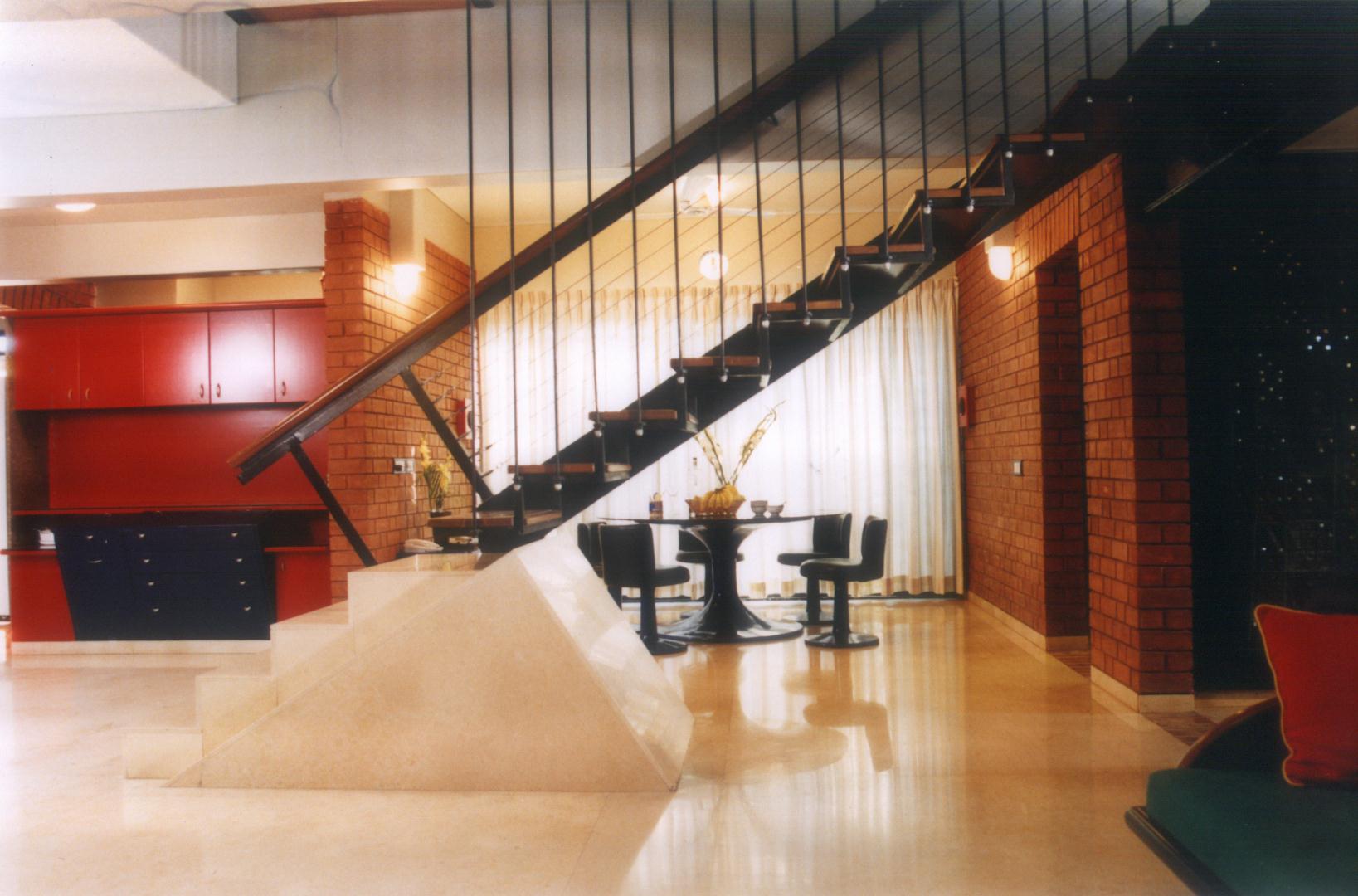 Staircase partitioning living and dining zones