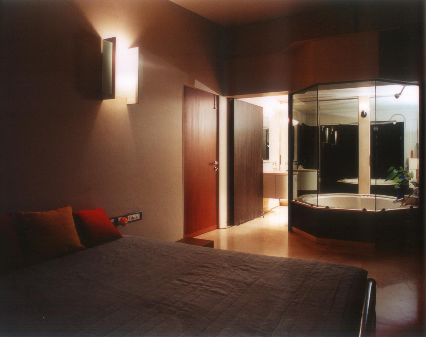 Bedroom space extending into the bathroom as a single private space
