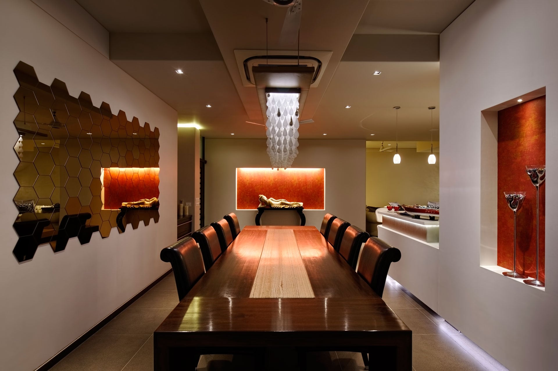 Rusty red niches and artwork add warmth to the formal dining area