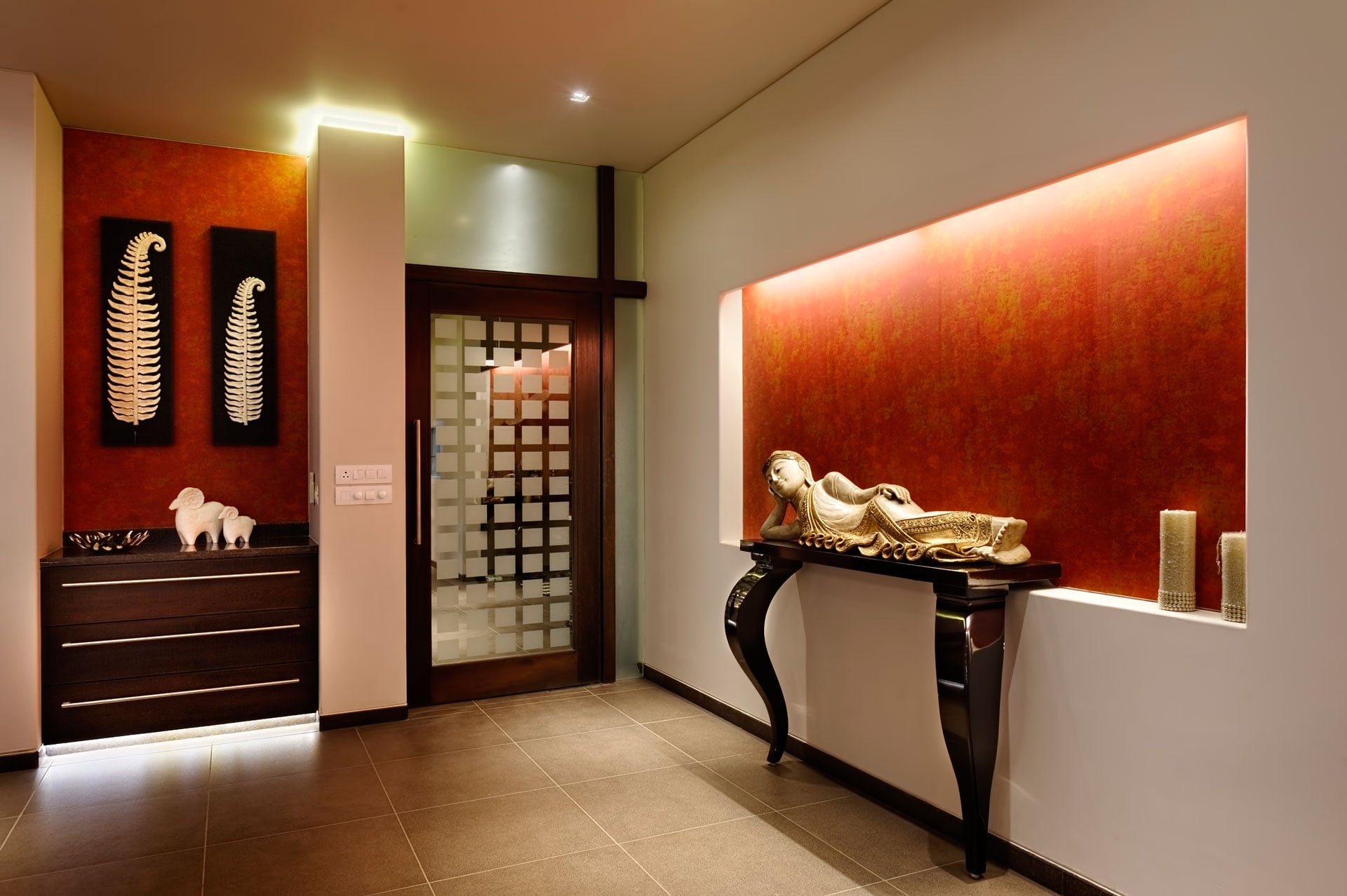 A reclining Buddha Artifact adds a sense of serenity to the dining room