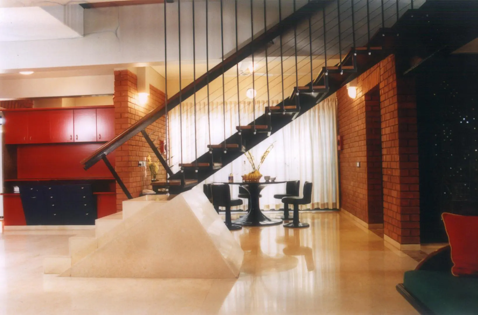Staircase partitioning living and dining zones